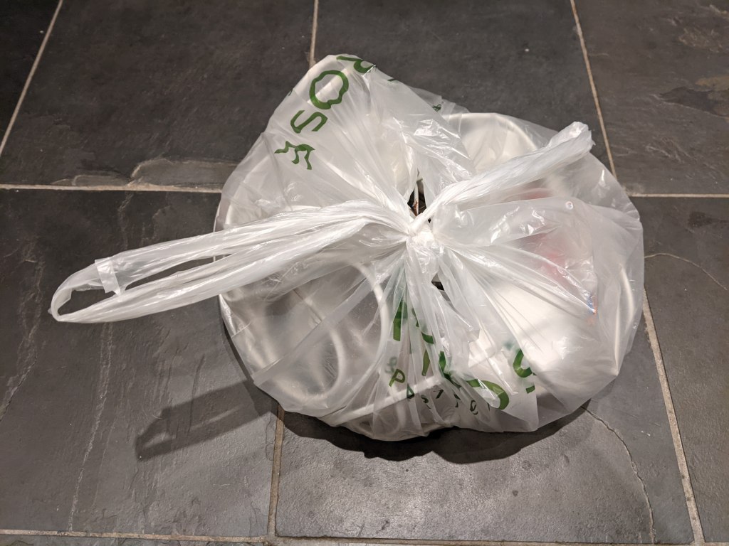 Rubbish bag with old lighting parts in it.
